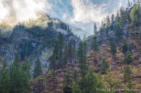 Sun lifting the clouds on the mountain peaks